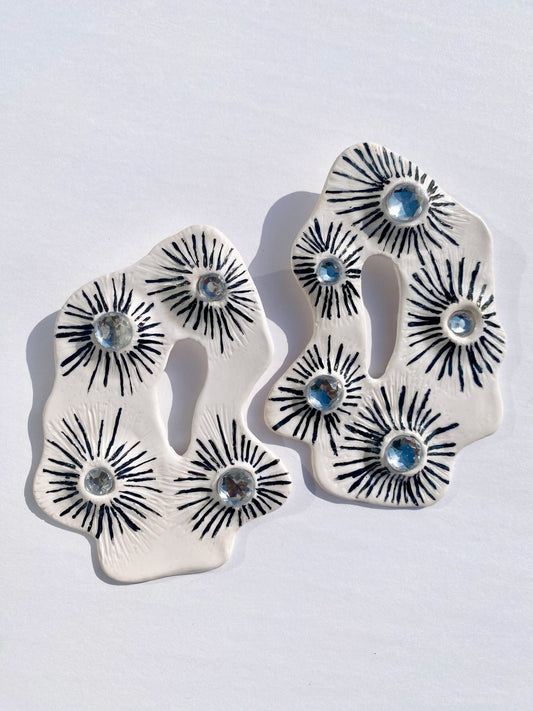 The Celeste Statement Earrings made with polymer clay and hand painted with black paint and added faux diamond jewels 